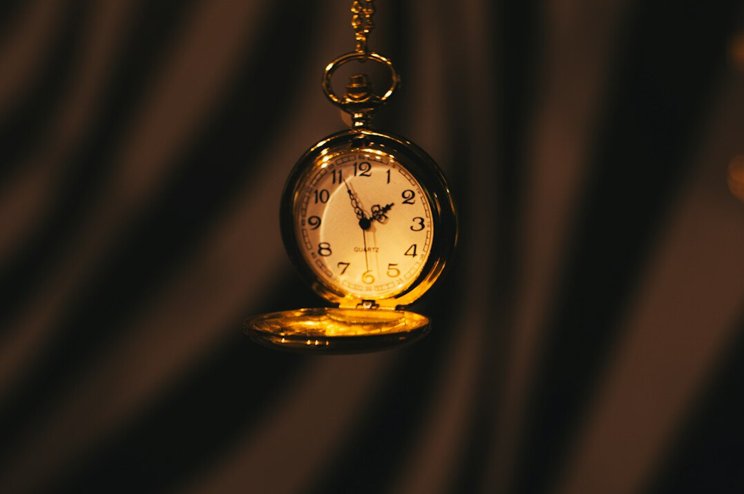 Antique gold pocket watch open on dark velvet