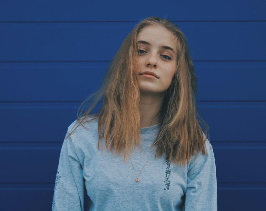 Portrait of a young woman with light brown hair and a calm expression